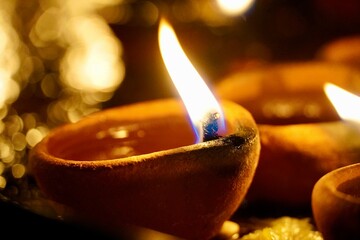 Burning oil lamps in the dark. Oil lamps lightened up during the festival at India. Lamps fired at...