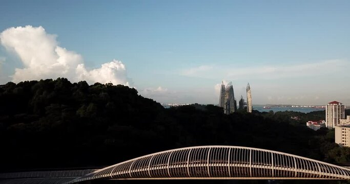 Aerial View, Henderson Waves Footbridge and Keppel Bay in Background, Singapore on Sunny Evening, Pull Back Drone Shot