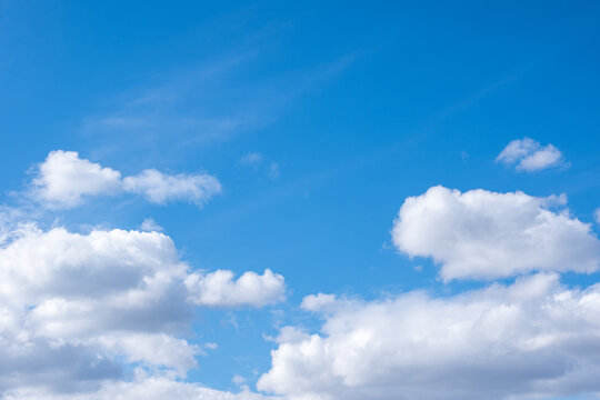 Blue sky with white cumulus clouds, copy space. Perfect natural sky background for your photos
