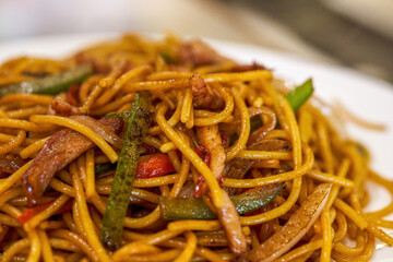 A Cantonese-Italian fusion dish, fried pasta with beef tenderloin with colored peppers