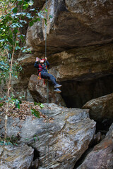 Beautiful young Asian climbers are climbing the high cliffs of northern Thailand.