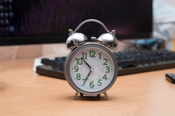 Working hours.Concept.Watch the alarm clock next to the computer.