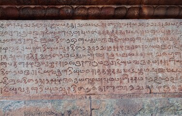 Inscriptions of Tamil language carved on the stone walls at Brihadeeswarar temple in Thanjavur,...