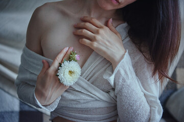 Portrait of a girl with a flower near her face