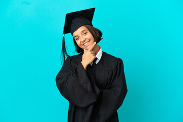 Young university graduate girl over isolated blue background happy and smiling