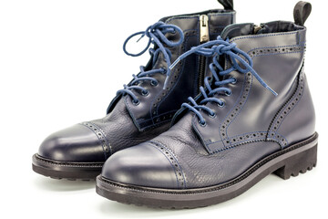 Dark blue men's boots made of genuine leather, with on a black background, beauty and fashion,
