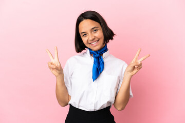 Airplane stewardess over isolated background showing victory sign with both hands