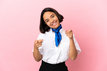 Airplane stewardess over isolated background pointing front with happy expression