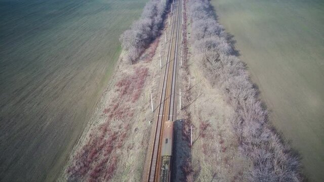 helicopter over the train going through the flat steppe