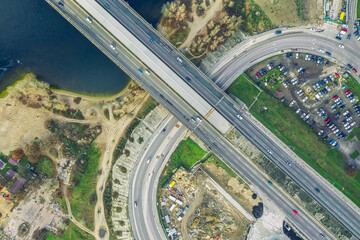 Fototapeta na wymiar Kiev, Ukraine - January 02, 2021, top view of a traffic junction from the air, car traffic and traffic jams from many cars, transport concept