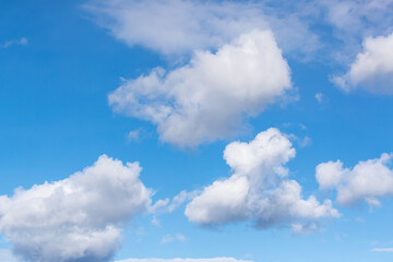 Naklejka na ściany i meble White cumulus clouds and a blue sky. Shot in Sweden, Scandinavia