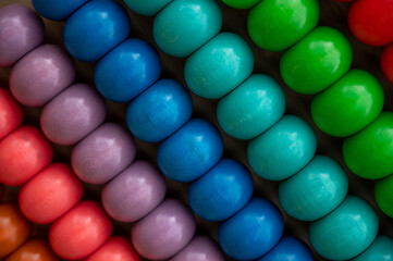 Colourful wooden abacus background close-up. Vibrant macro photo.
