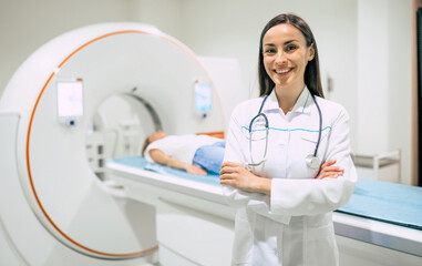 Confident female doctor oncology in magnetic resonance imaging or computed tomography room of a...