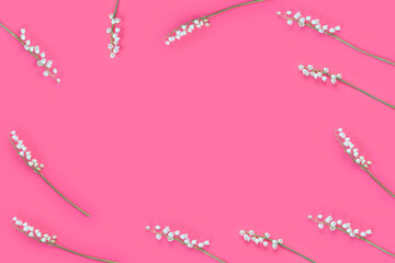 Pink background with white delicate lily of the valley flowers for mother's day card.