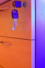 Key in office cabinet lock  .  Led blue lights side lit. Copy Space.