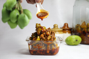 Very Popular homemade mango pickle or kache  aam ka aachar msde in India during summer season.