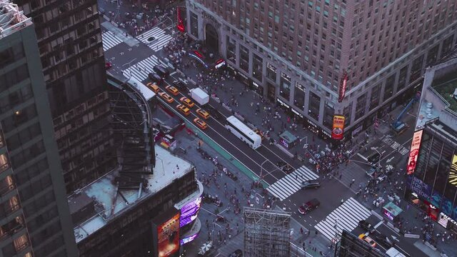 NYC: Times Square from above closeup shot of traffic, pedestrians, intersections, billboards and neon lights, looking at the base of the Paramount Building - New York City, USA