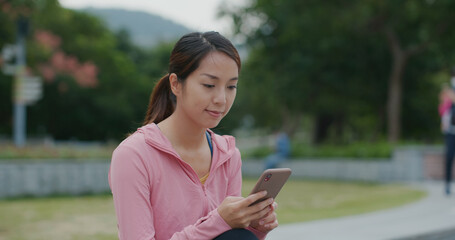 Woman uses mobile phone at park