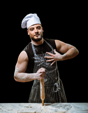 Handsome sexy chef in flour with rolling pin 
