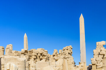 Granite obelisk against blue sky in a Karnak temple. Luxor, Egypt.