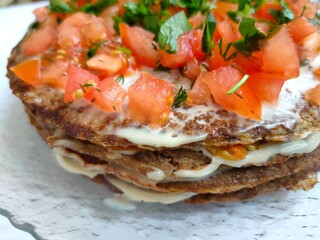 liver cake with filling decorated with herbs and tomato slices