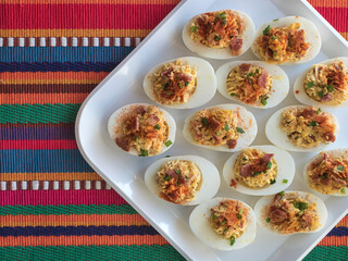 Deviled Eggs Overhead on Tray and Colorful Placemat Horiz