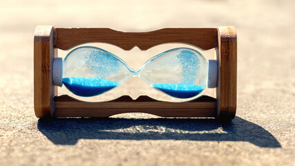 Hourglass lies on the concrete. Time stop concept