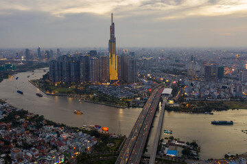 Naklejka premium op view aerial of center Ho Chi Minh City and Saigon bridge with development buildings, transportation, energy power infrastructure. Financial and business centers in Vietnam. View from District 2