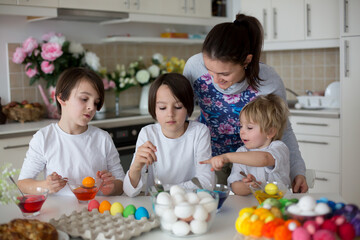 Children, boy siblings, coloring eggs for Easter