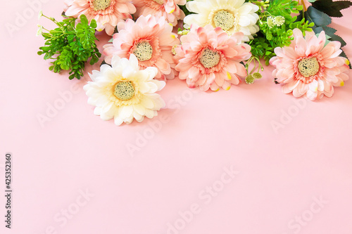 Mother's day or birthday greeting card concept. Festive flower arrangement on a pastel pink background. Copy space.