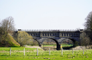 Three arch bridge in Olfen. Environment with a meadow and bare trees. Landscape in North Rhine...