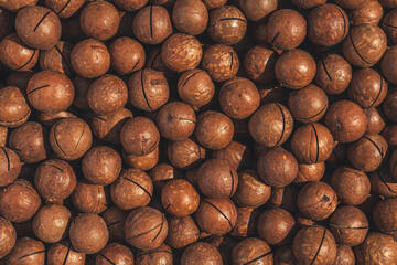 many organic macadamia nuts close-up, top view.