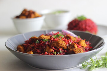Beetroot pulao, a one pot rice preparation with basmati rice, beetroot, onions and spices. Served with air fried chicken bites and curd.
