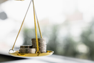 Coins stack with balance scale. Money management, financial plan, time value of money, business...
