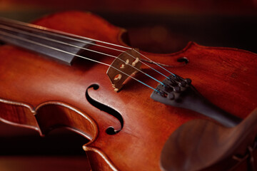 Violin in retro style and bow on wooden table