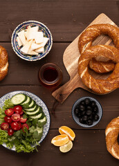 Traditional Turkish bagel simit, breakfast, on a wooden table, rustic, horizontal, no people,