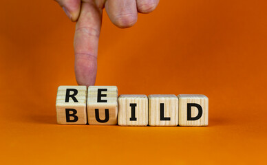 Rebuild symbol. Concept word 'rebuild' on wooden cubes on a beautiful orange table. Businessman...