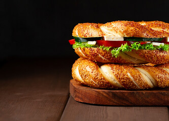 Traditional Turkish bagel simit, breakfast, on a wooden table, rustic, horizontal, no people,