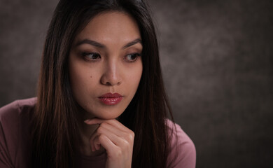 Young pretty woman with thoughtful facial expression - studio photography