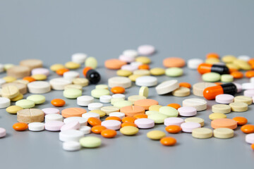 Colorful pills on a gray background. The concept of drug diversity in the modern world