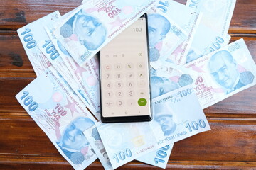 Moneys with smart phone's calculator to make economy on table, Turkish liras