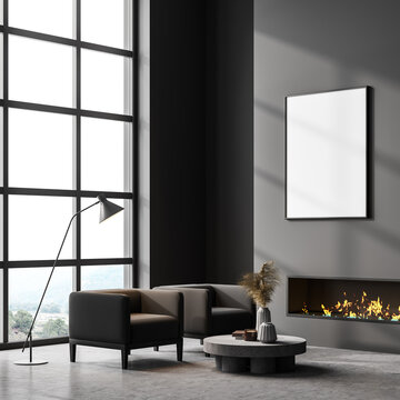 Grey room interior with fireplace, armchairs and lamp near window, poster