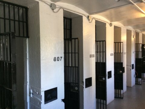 Numbered jail cells with opened black bars doors. Old Ottawa jail. Ottawa, Ontario, Canada.