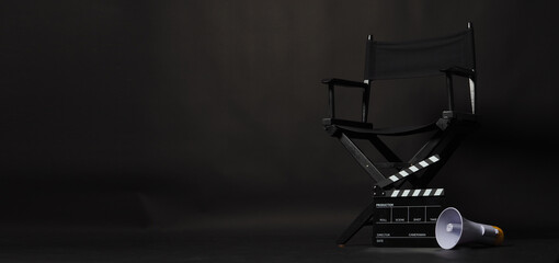 Fototapeta na wymiar Black director chair and Clapper board or movie Clapperboard with megaphone on black background.use in video production or film cinema industry