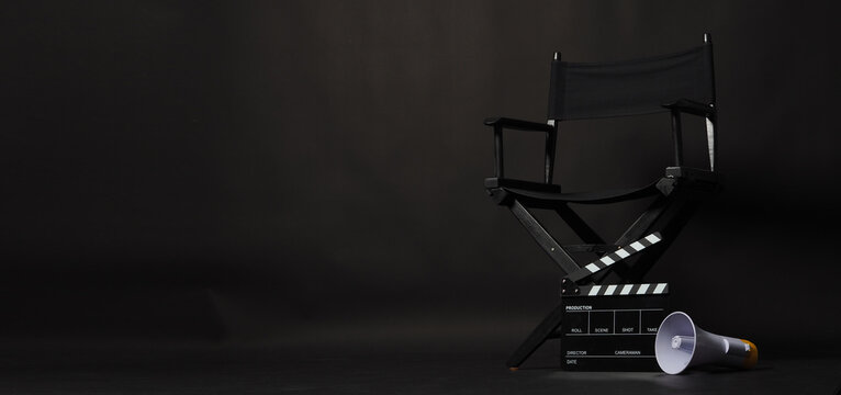 Black director chair and Clapper board or movie Clapperboard with megaphone on black background.use in video production or film cinema industry