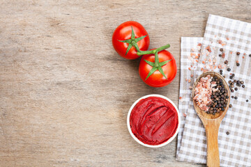 Tomato paste on wooden background.