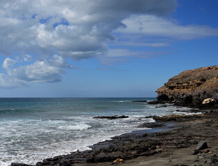 Fototapeta na wymiar Beach with rocks and sand, coast of Jandia, south of Fuerteventura, Canary Islands