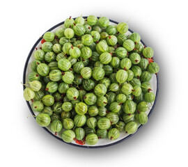 Fresh green gooseberries in a plate close-up, isolated. The view from top
