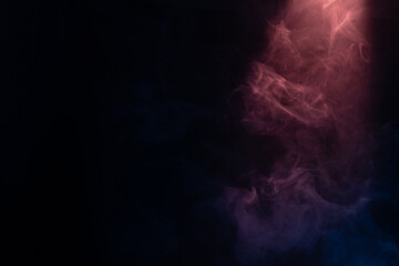 Obraz premium Blue and pink steam on a black background.