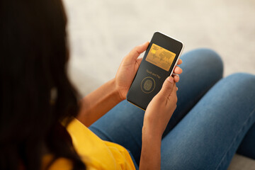 Woman Using Phone While Sitting On Couch, paying with touch